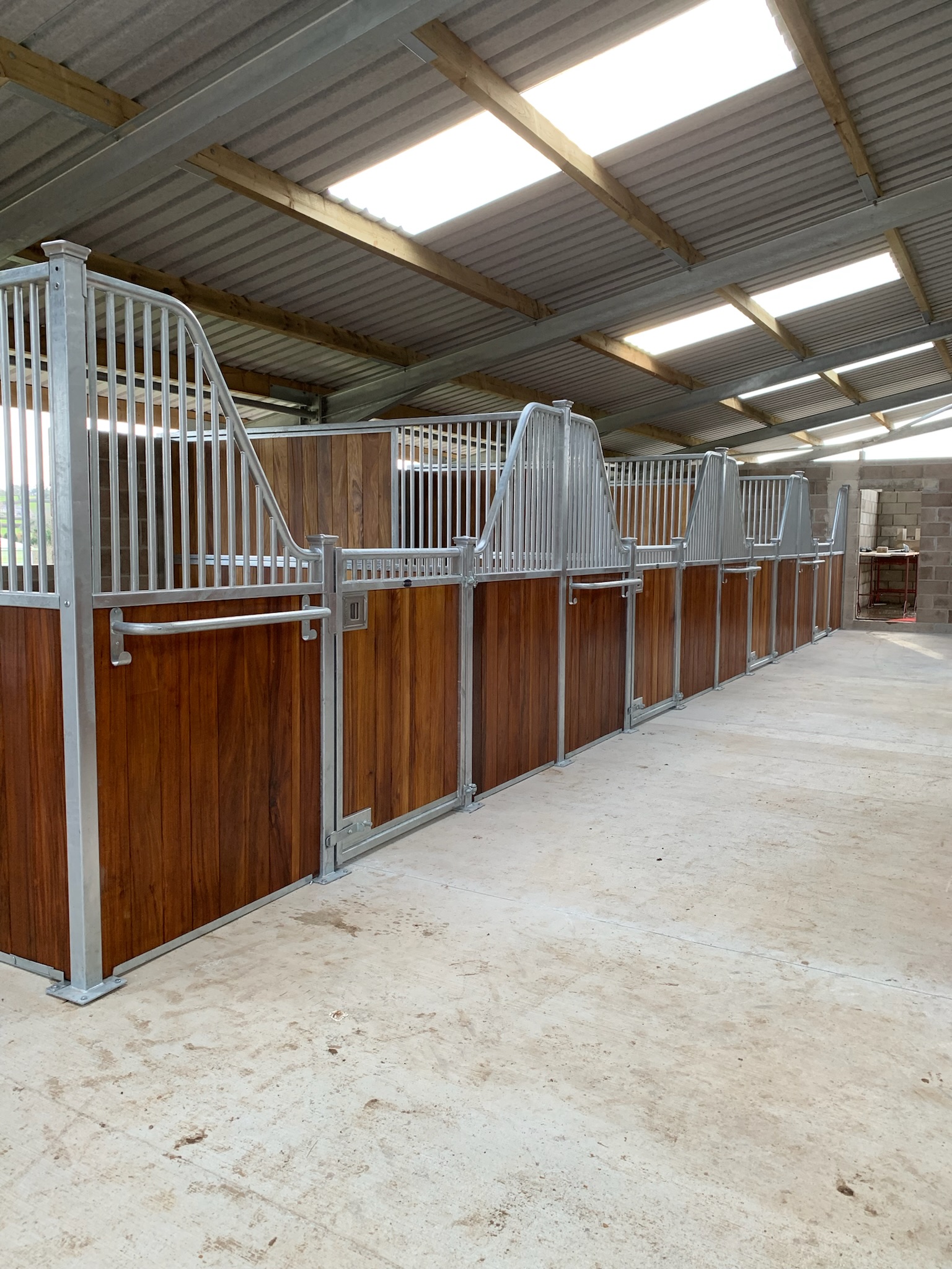 Modern internal stable design with clean, linear square post profiles.